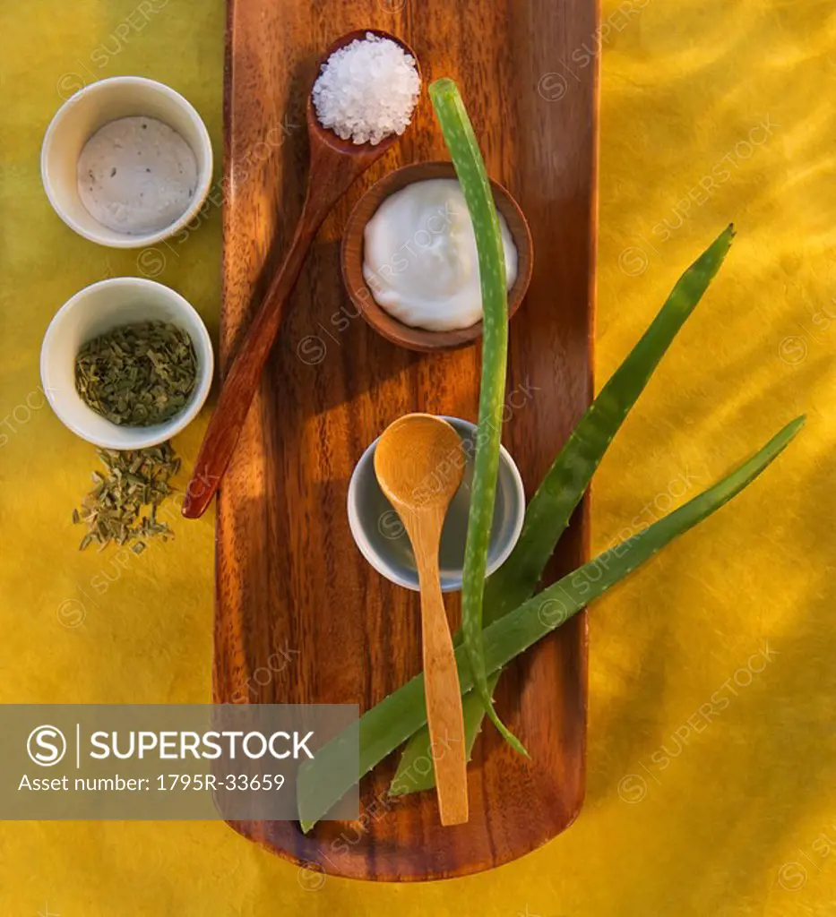 Aloe Vera dried herbs lotion and salt on wooden tray