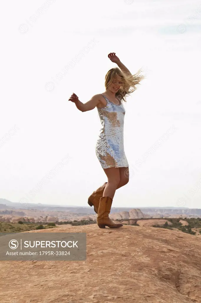 Young woman dancing on rocks
