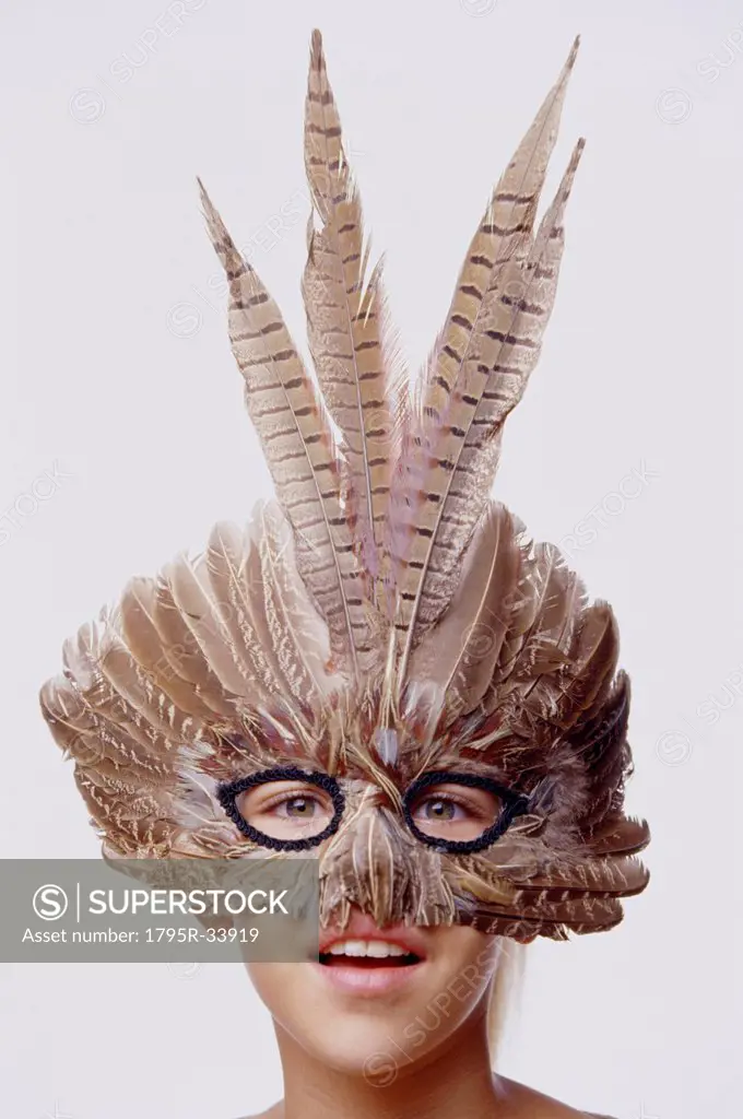 Child wearing a feather mask