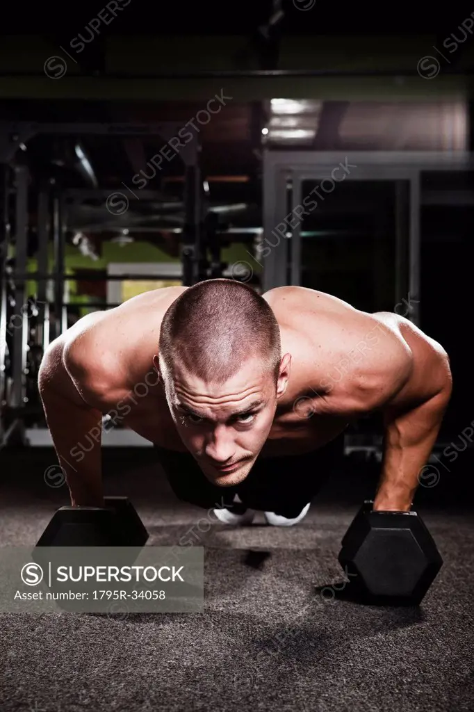 Mid adult man working out in gym