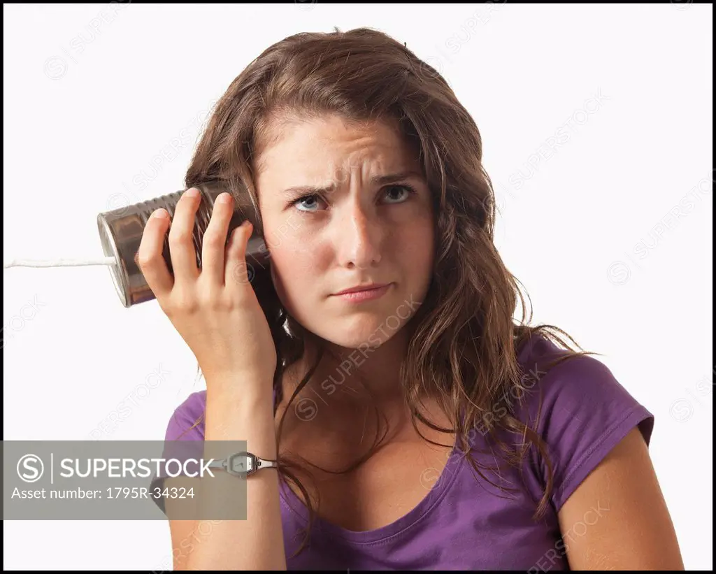 Young woman holding tin can phone