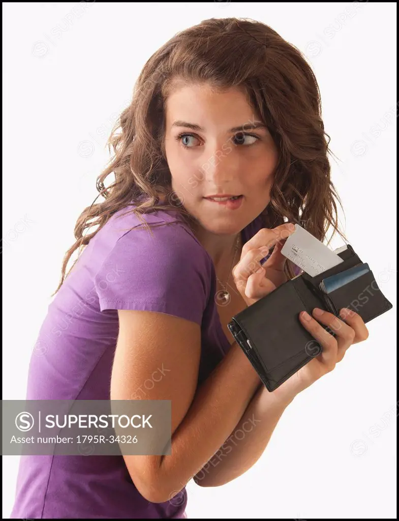 Young woman removing banknote from wallet