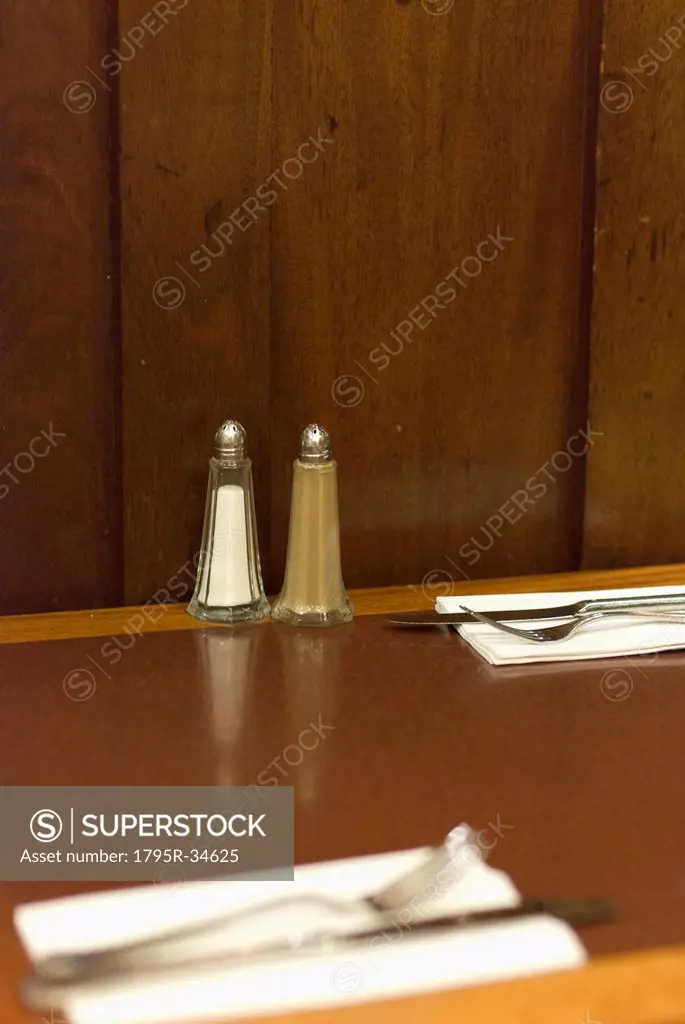 Salt and pepper condiments on cafe table