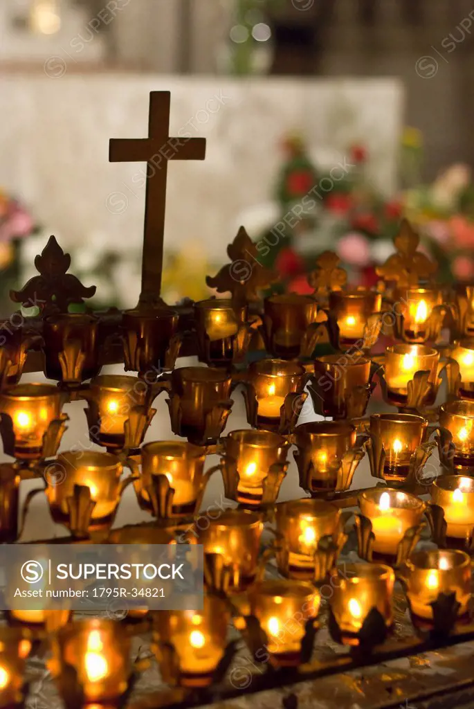 Cross with candles in cathedral