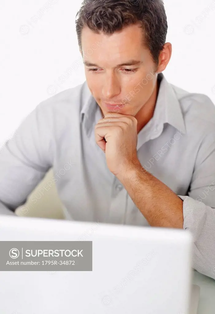 Portrait of good_looking mid adult man working on laptop
