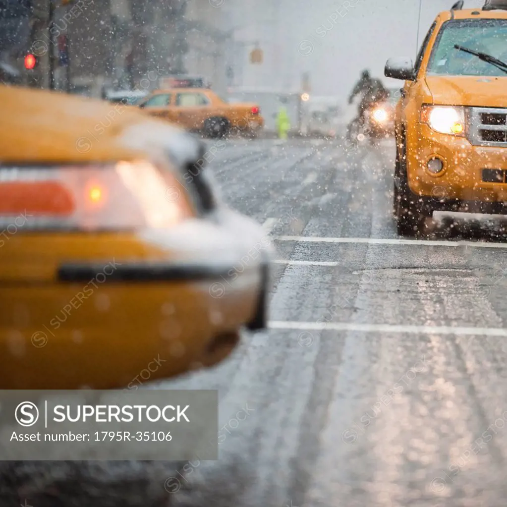 USA, New York, New York City, Close_up of yellow cab on street in snow