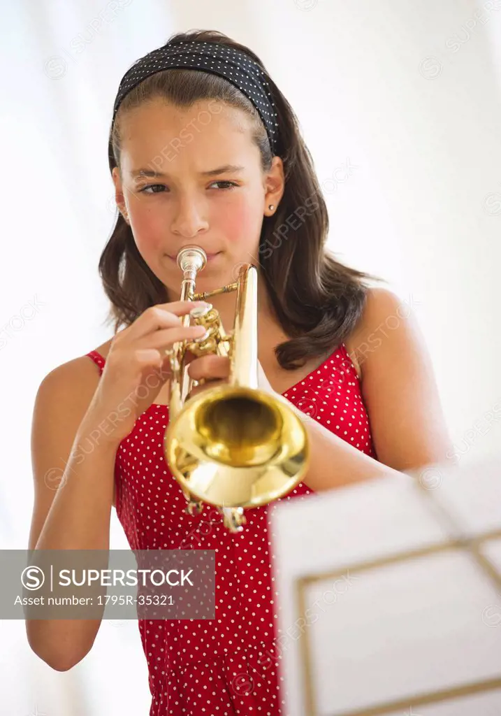 Girl 12_13 playing trumpet