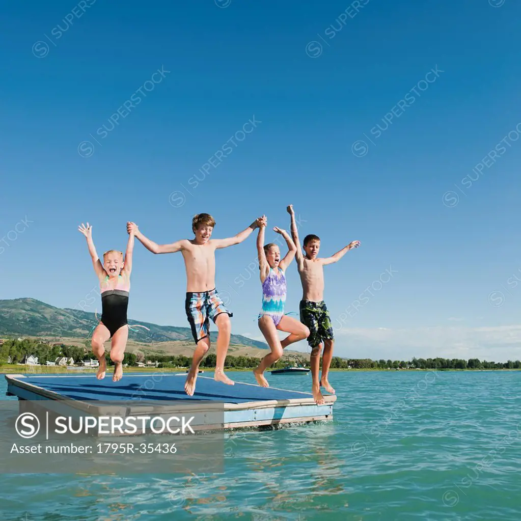Kids 6_7,8_9,10_11,12_13 playing on raft on lake
