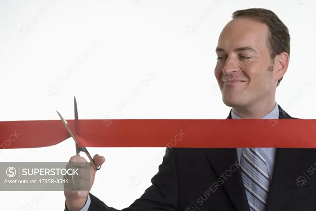 Businessman cutting a ribbon