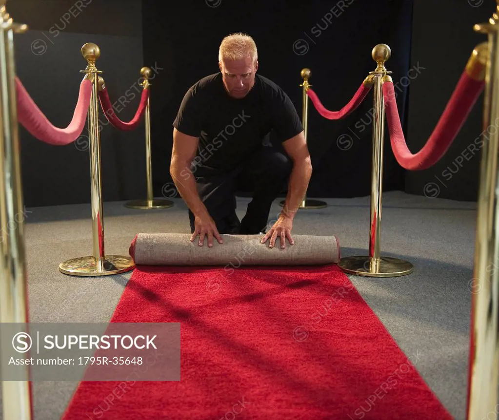 Bouncer rolling red carpet