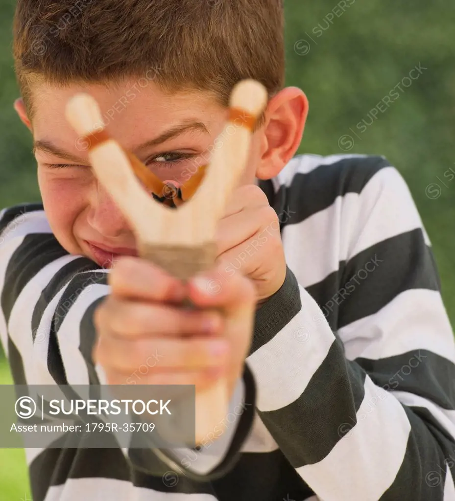 Boy 10_11 using slingshot
