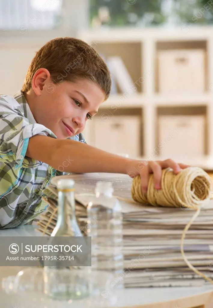 Boy 10_11 sorting garbage at home