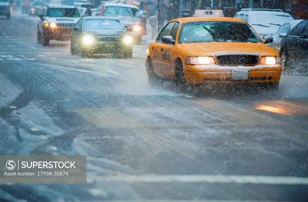 USA, New York, New York City, Traffic on street in snow