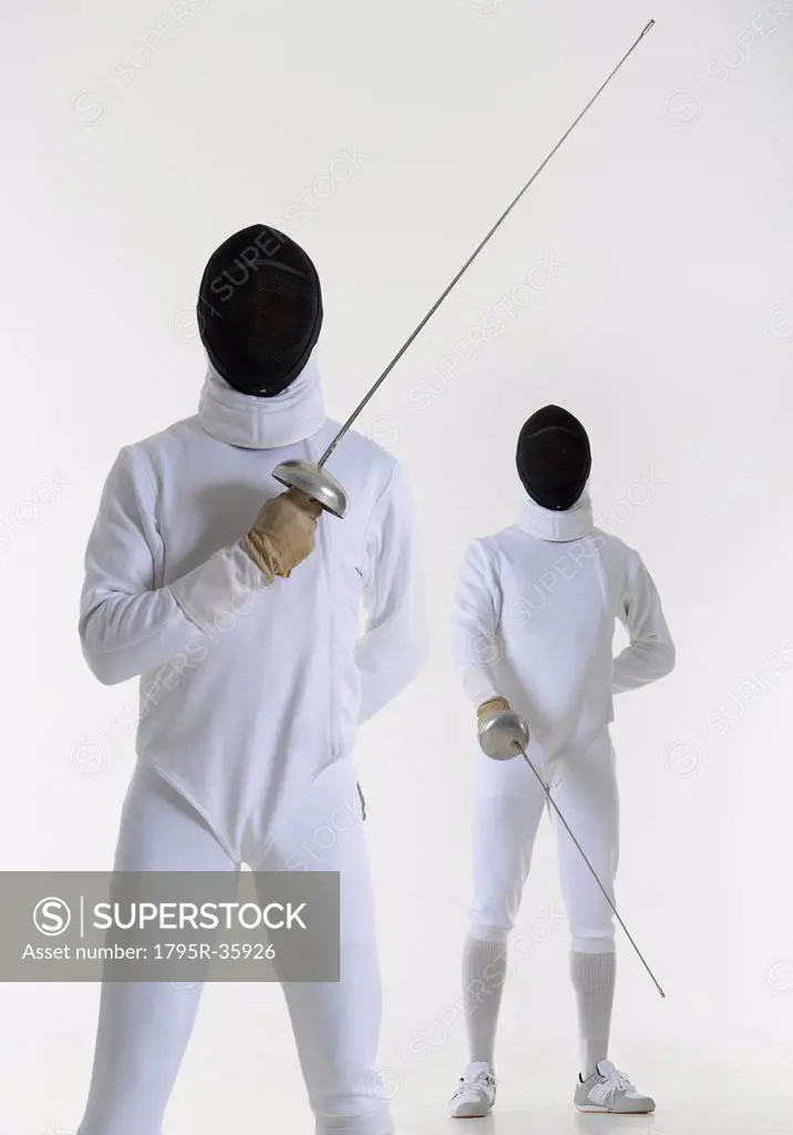 Studio portrait of fencer holding fencing foil