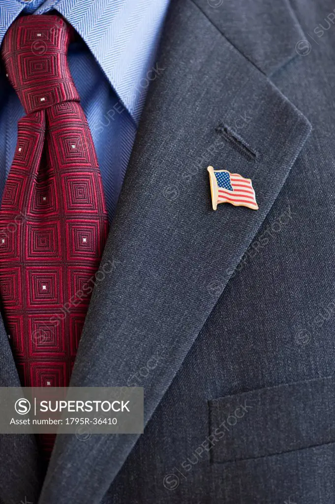Business suit with pin of American flag on lapel