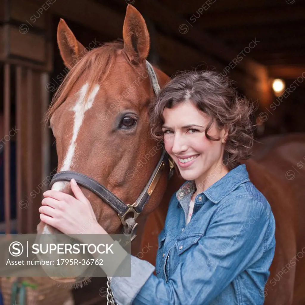 Woman holding horse