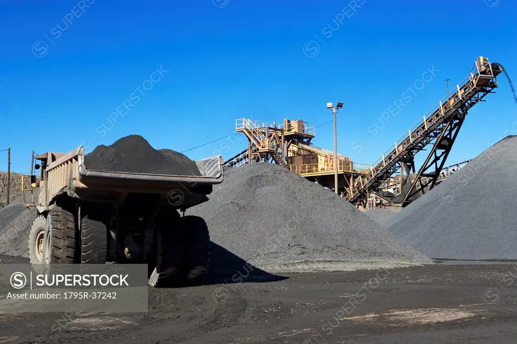 Truck and gravel piles