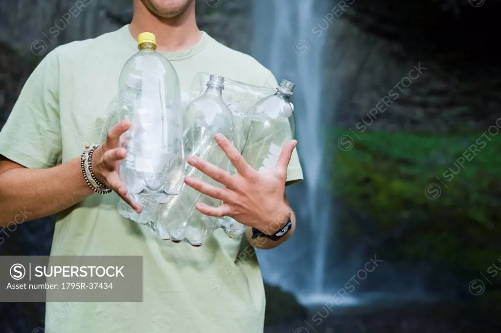 Man holding empty water bottles