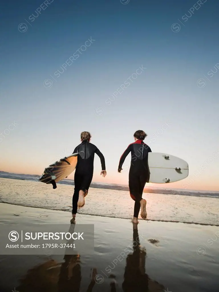 Kids on beach with surfboards