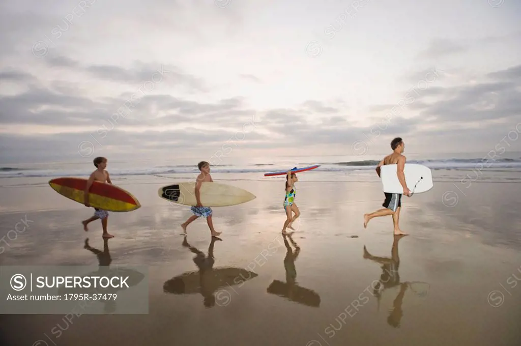 Family carrying surfboards
