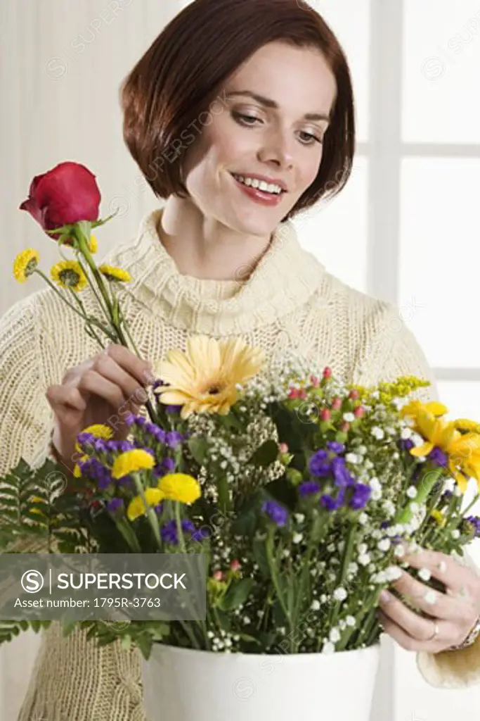 Portrait of woman arranging flowers