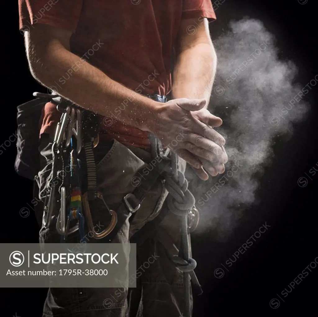Male climber applying chalk to hands