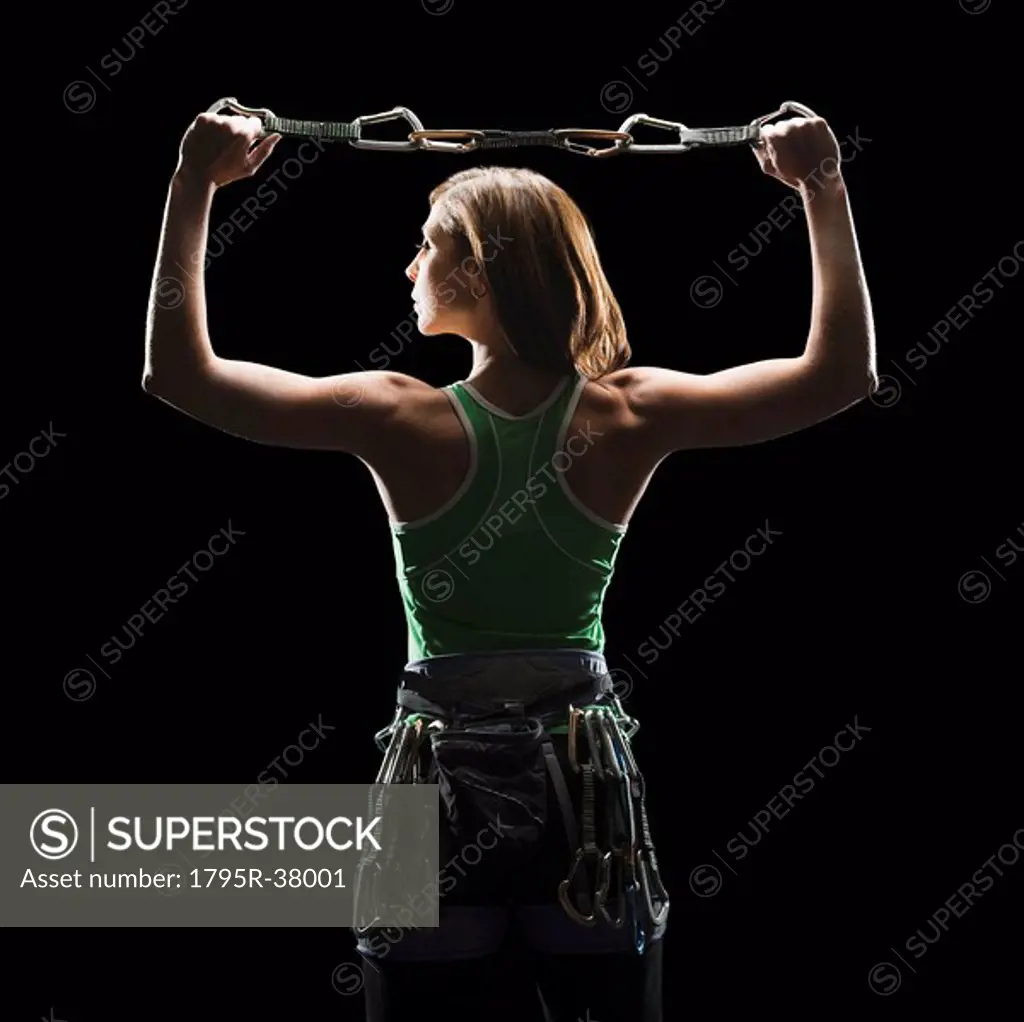 Female climber holding gear
