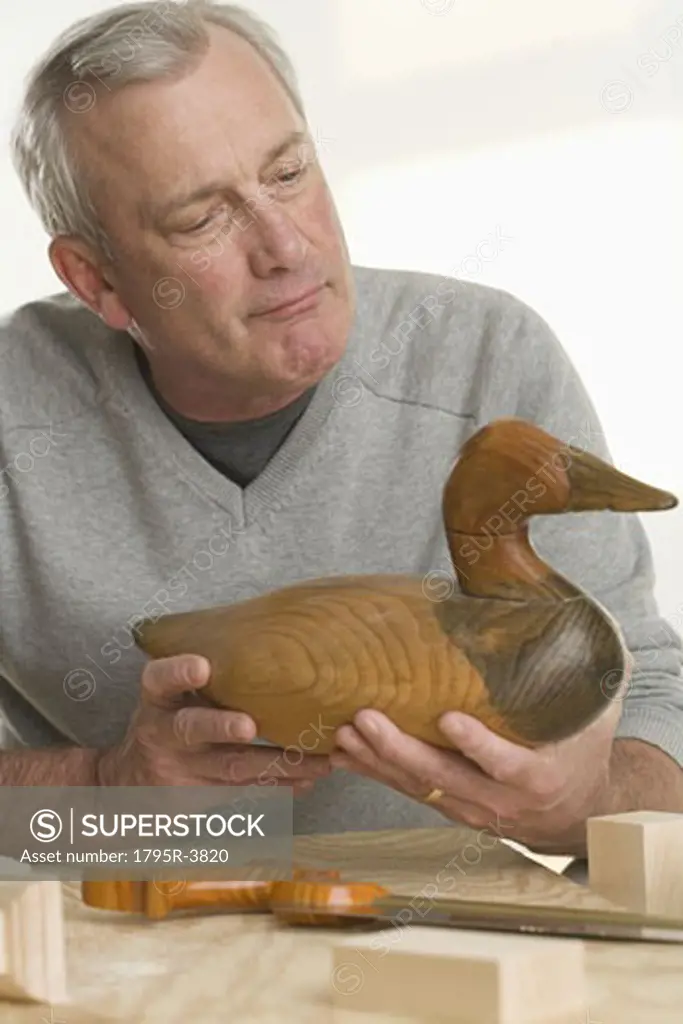 Man holding handmade wooden duck