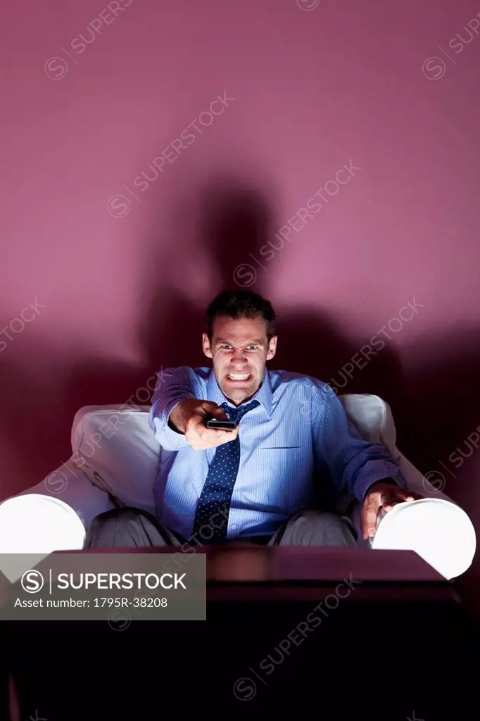 Angry man using remote control