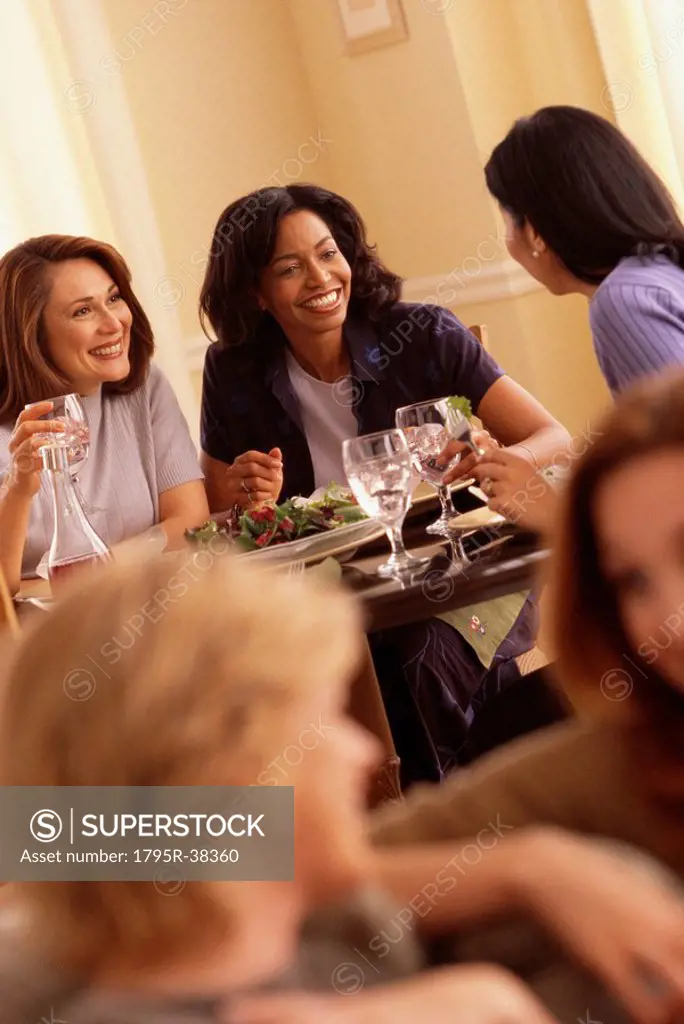 Woman laughing over dinner
