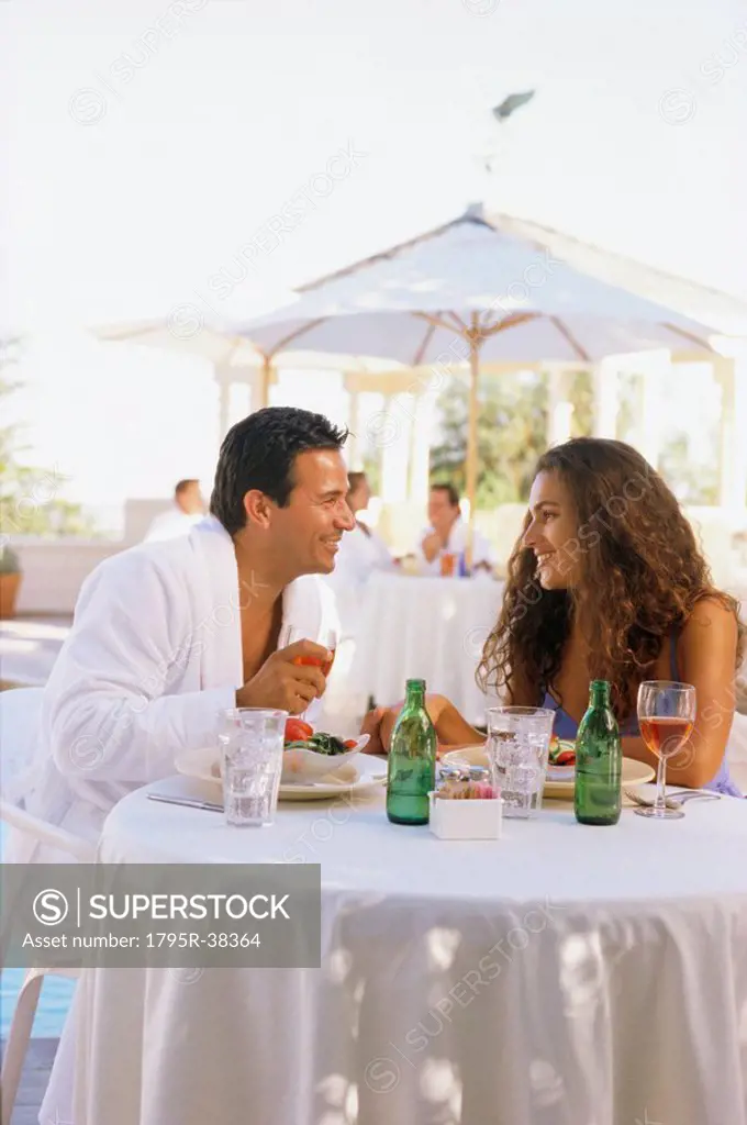 Couple in robes eating outside