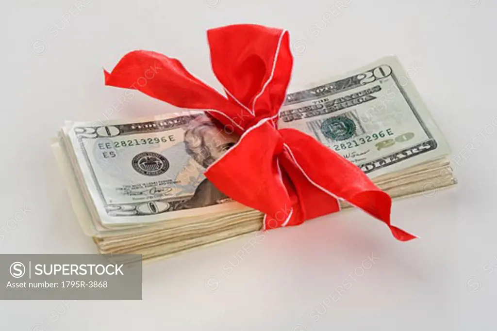 A stack of money with a bow