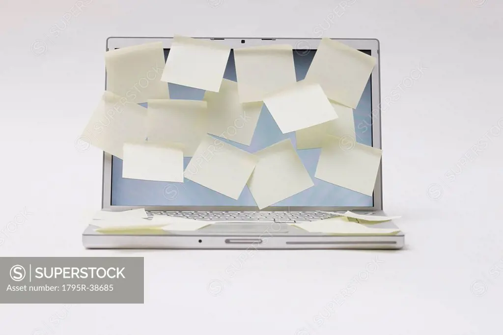 A laptop with blank memo notes