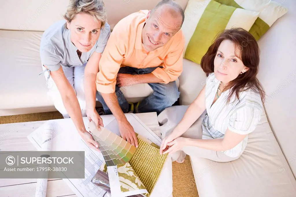 Couple choosing swatch colour with interior designer