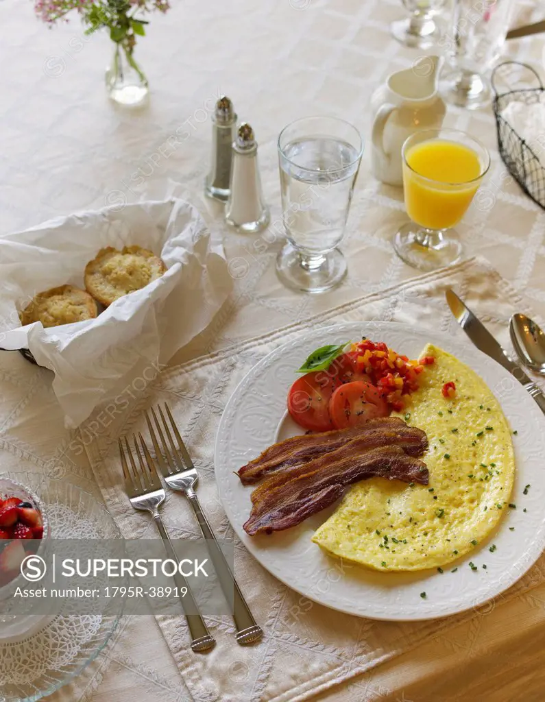 Bacon and omelet on breakfast table