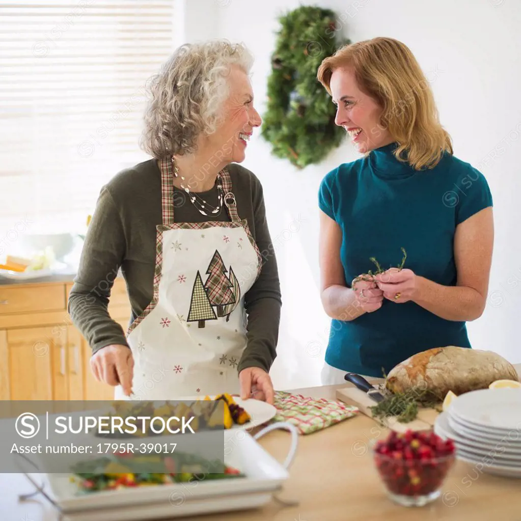 USA, New Jersey, Jersey City, Mother and daughter preparing food in kitchen