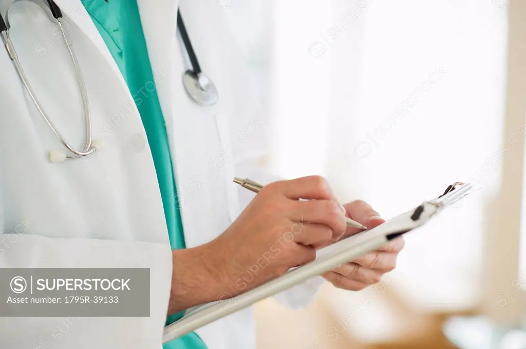 USA, New Jersey, Jersey City, Male doctor writing medical report