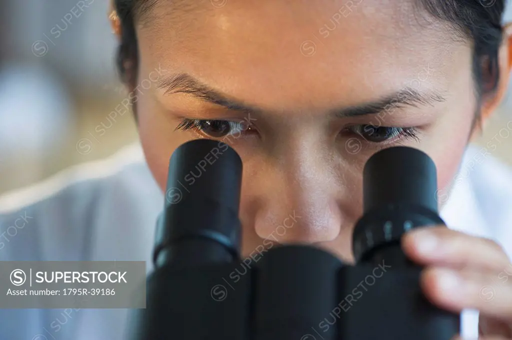 USA, New Jersey, Jersey City, Female scientist using microscope