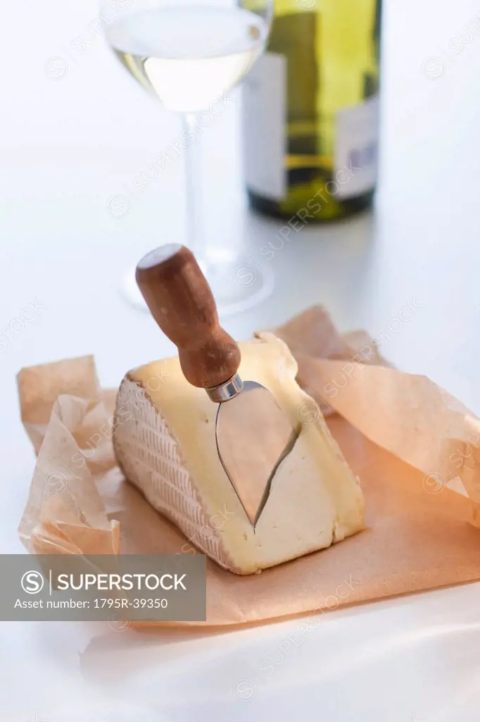 Slice of brie with cheese knife