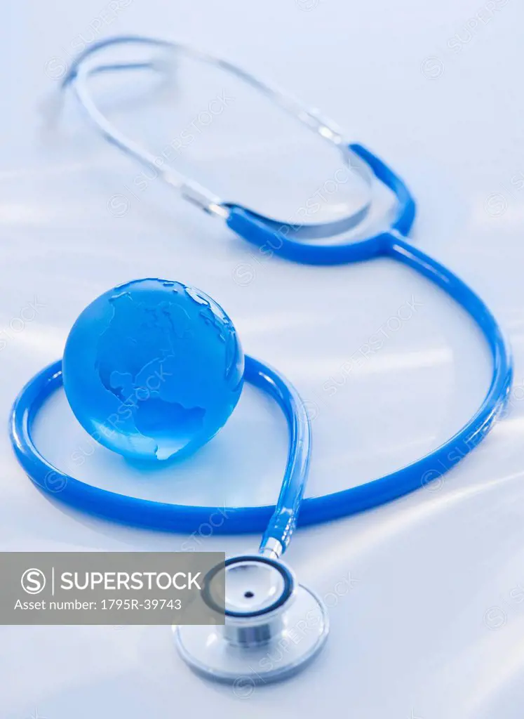 Close_up view of blue globe with stethoscope
