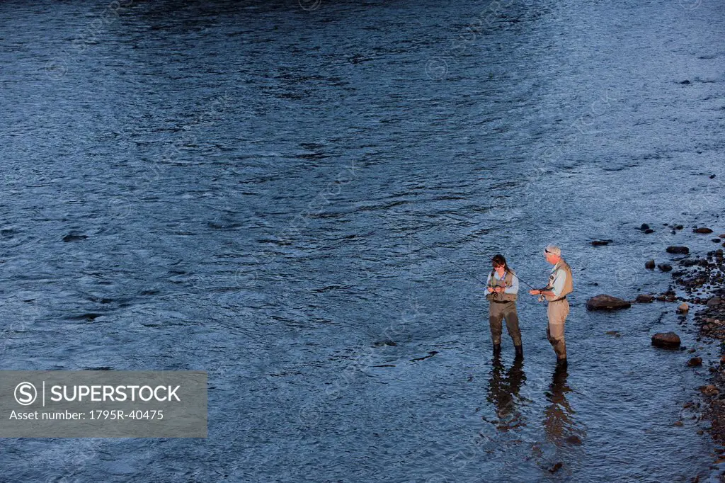 Canada, British Columbia, Fernie, Couple fly fishing in river