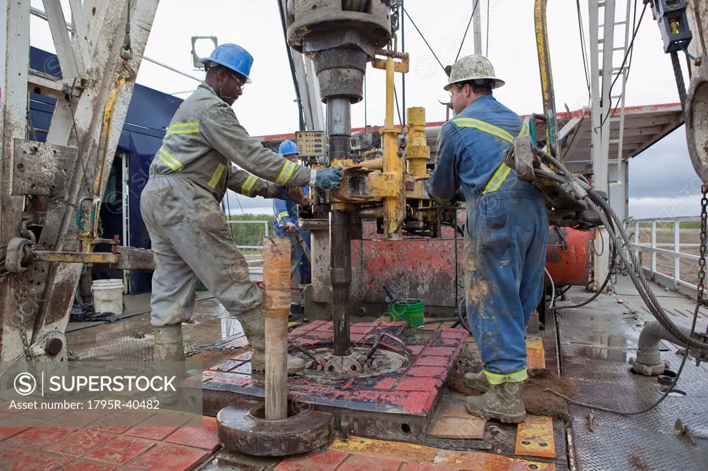 Oil workers drilling for oil on rig