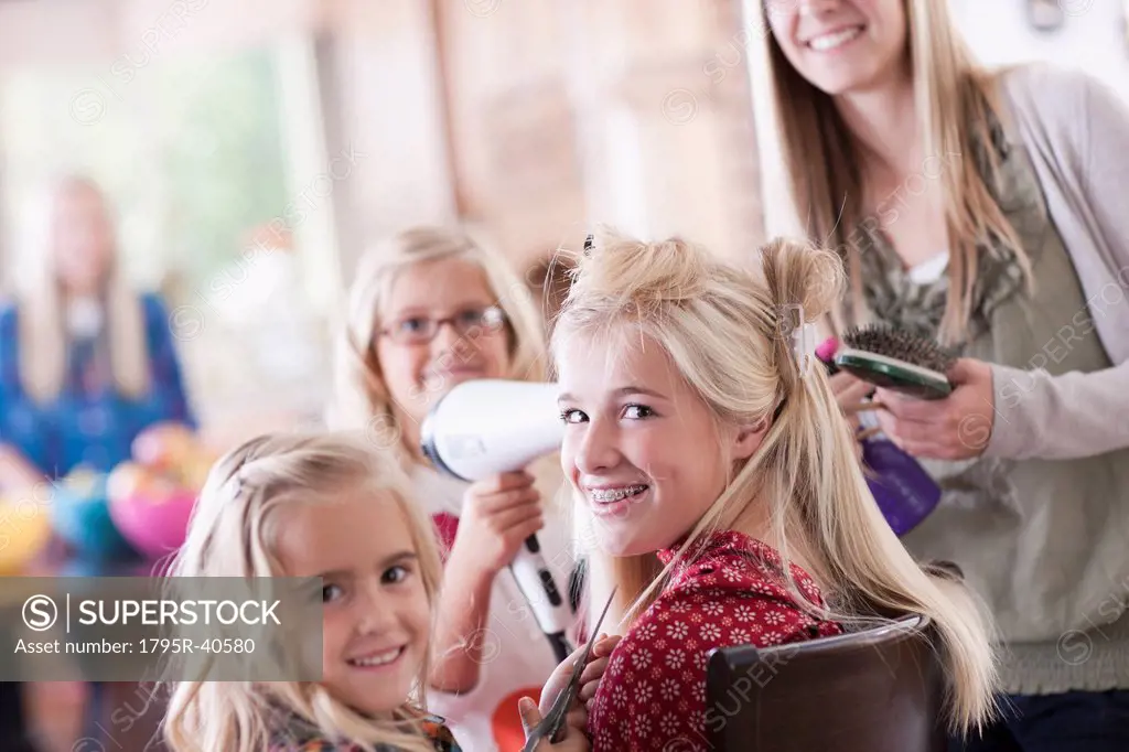 USA, Utah, family portrait of sisters 6_7, 8_9, 12_13, 14_15, 16_17 preparing hairs and having fun