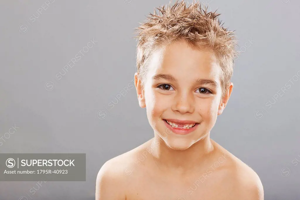 Studio portrait of toothless boy 8_9 smiling