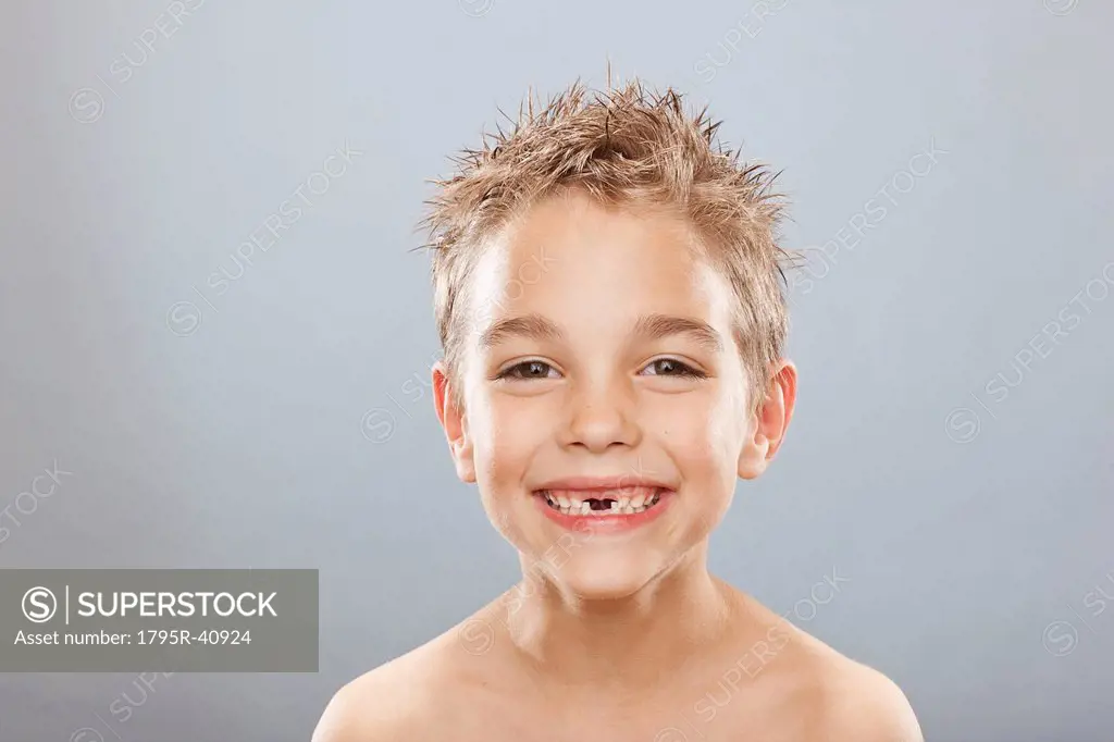 Studio portrait of toothless boy 8_9 smiling