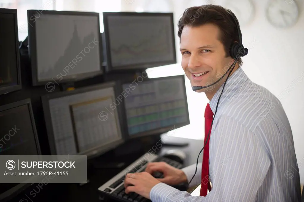 Portrait of financial worker analyzing data displayed on computer screen