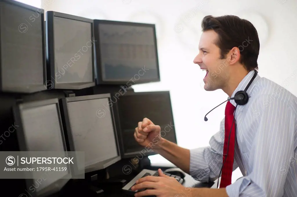 Financial worker analyzing data displayed on computer screen
