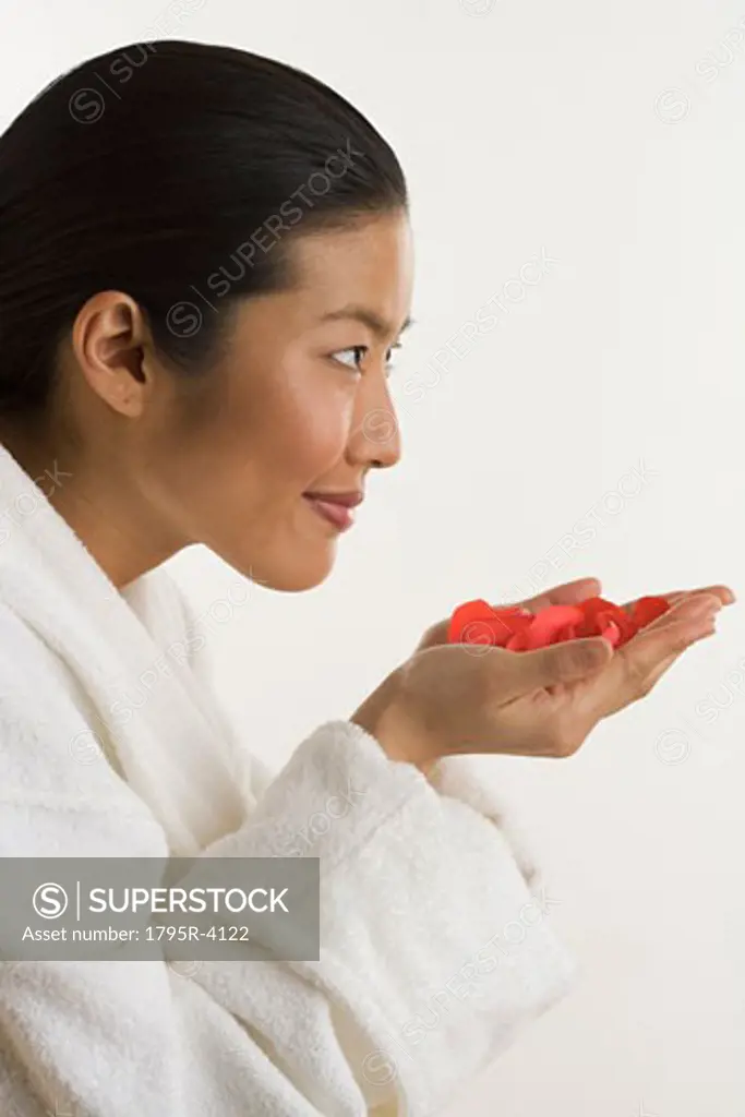Woman smelling rose petals