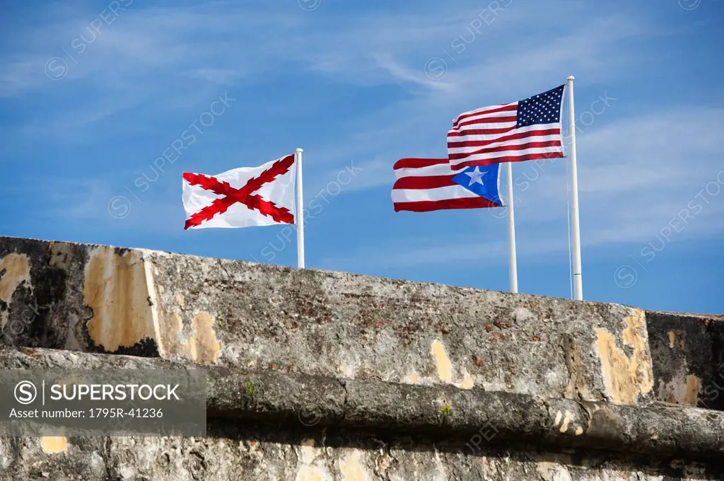 Puerto Rico, Old San Juan, El Morro Fortress, flags behind wall