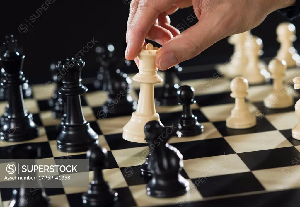 Close_up of man´s hand playing chess